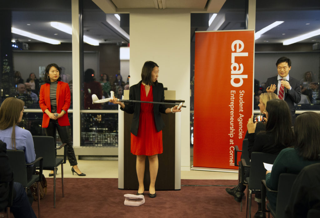 Jessica Tao, Jialin Ke, and Joshua Zhu demo the tool their startup, PediCure, developed to assist the elderly with toenail trimming. 