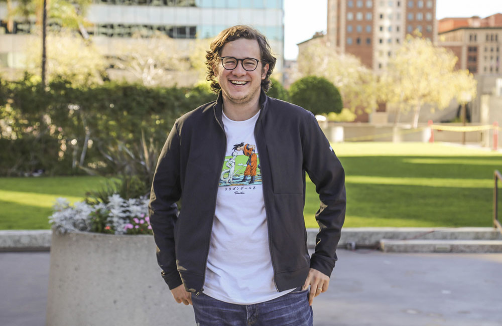 Pablo Borquez Swarzbeck, founder of ProducePay standing in front of a green lawn and buildings.