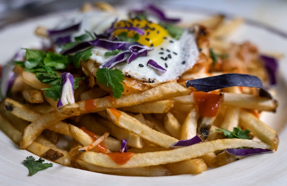Farther Farms' fries incorporated in kimchi poutine, served at Luna Inspired Street Food in Ithaca, New York.