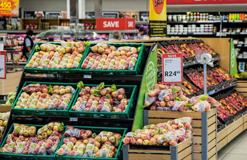 Fresh produce aisle with bins of apples.