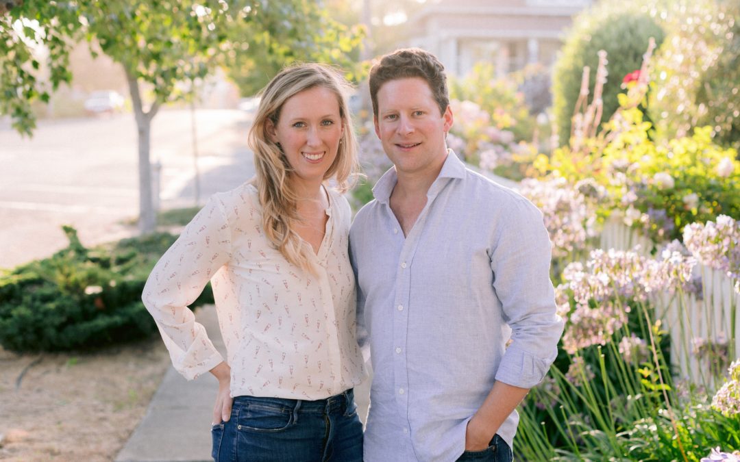 ulia and Alex stand outside on a sunny, spring day.